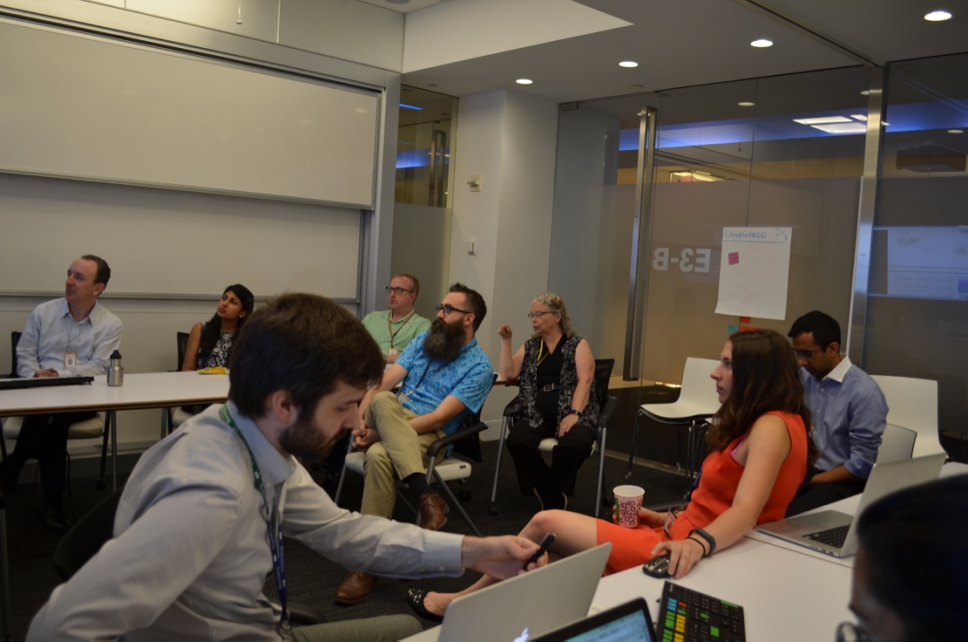 Team talking with designers at Bloomberg during design critic session.