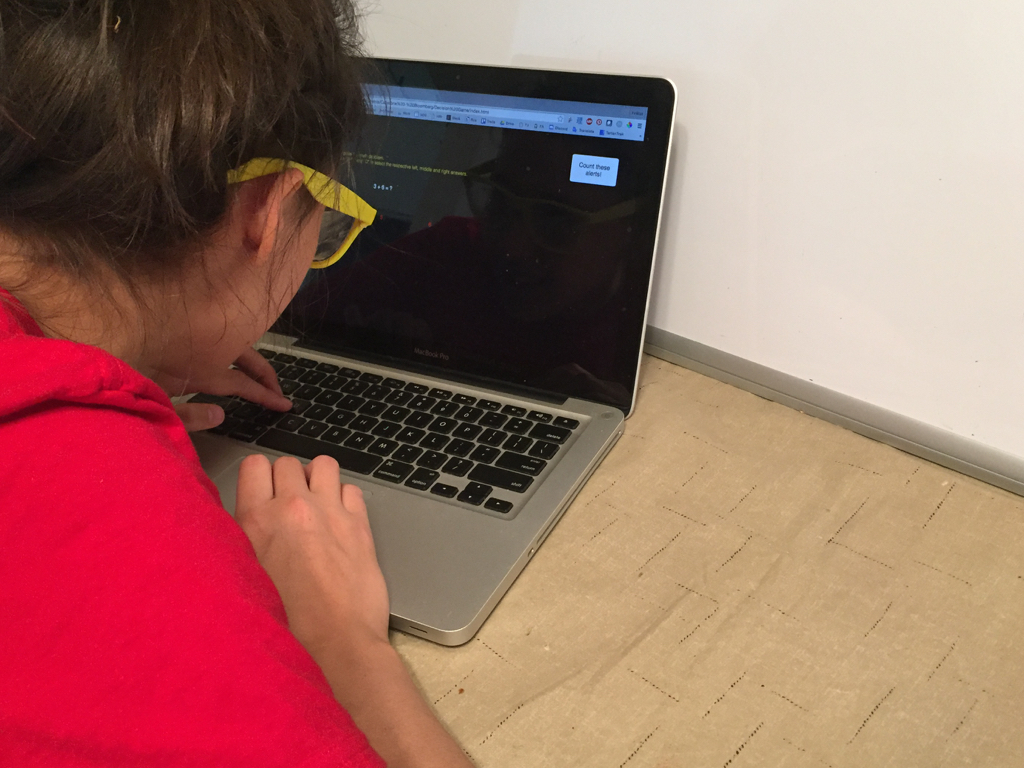 Student participant using computer simulation with blurred glasses.