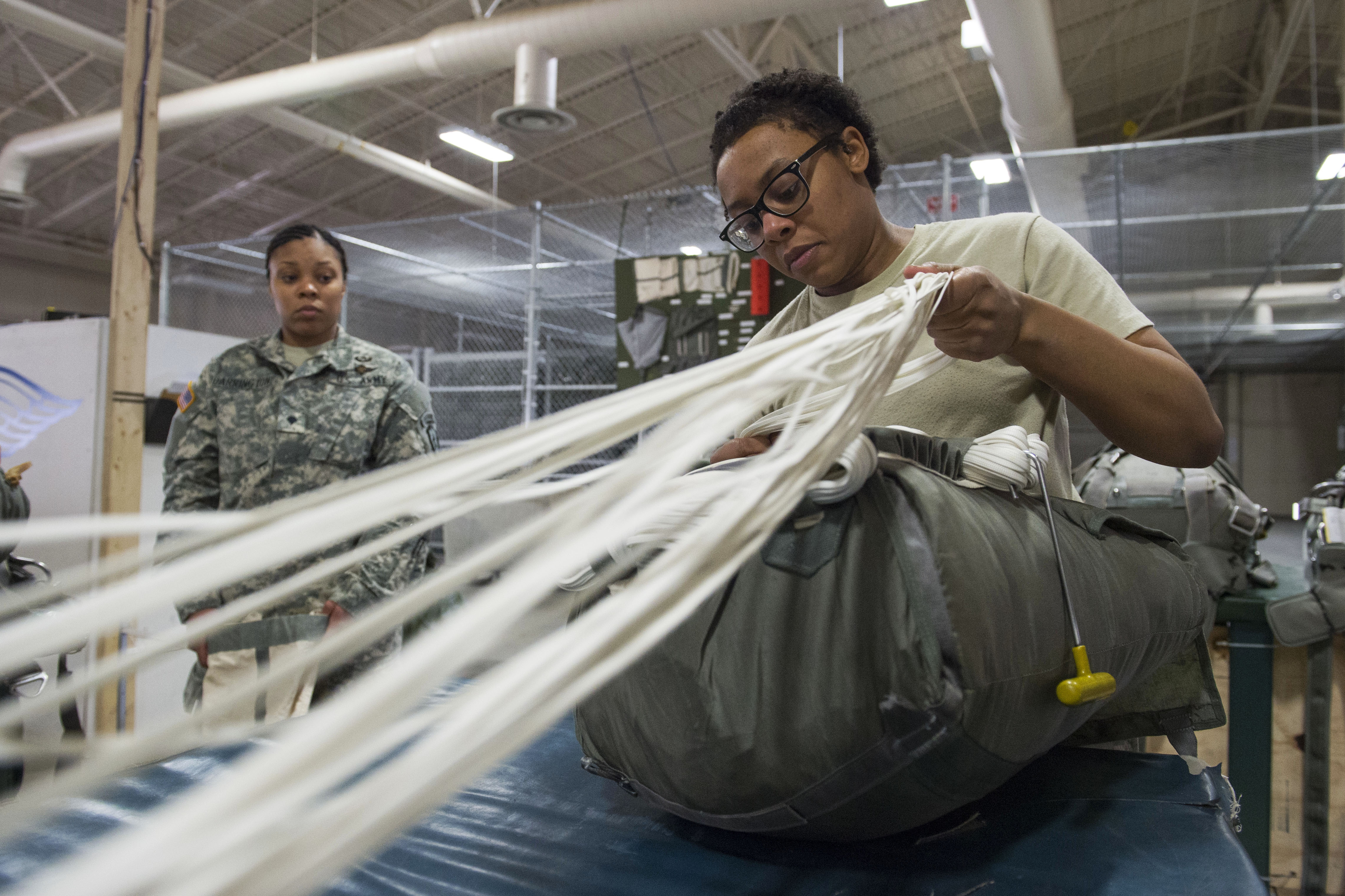 92R Rigger packing a T-11 Parachute