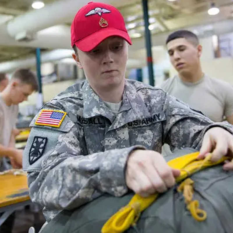 A rigger packing a T-11 Parachute