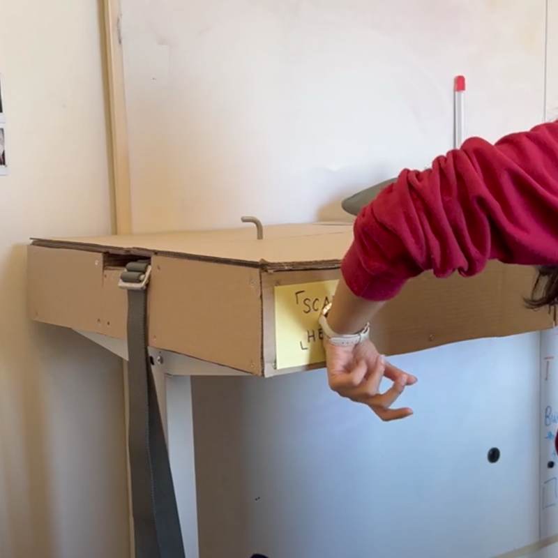 Cardboard Table Prototype with a paper scanning area for an RFID wristband