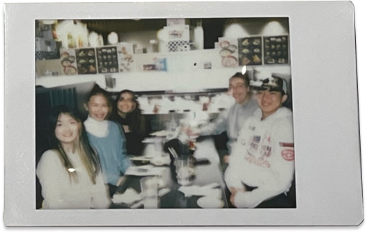 Polaroid photo of team at a restaurant table