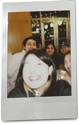 Polaroid of team selfie, with Yutong taking the photo