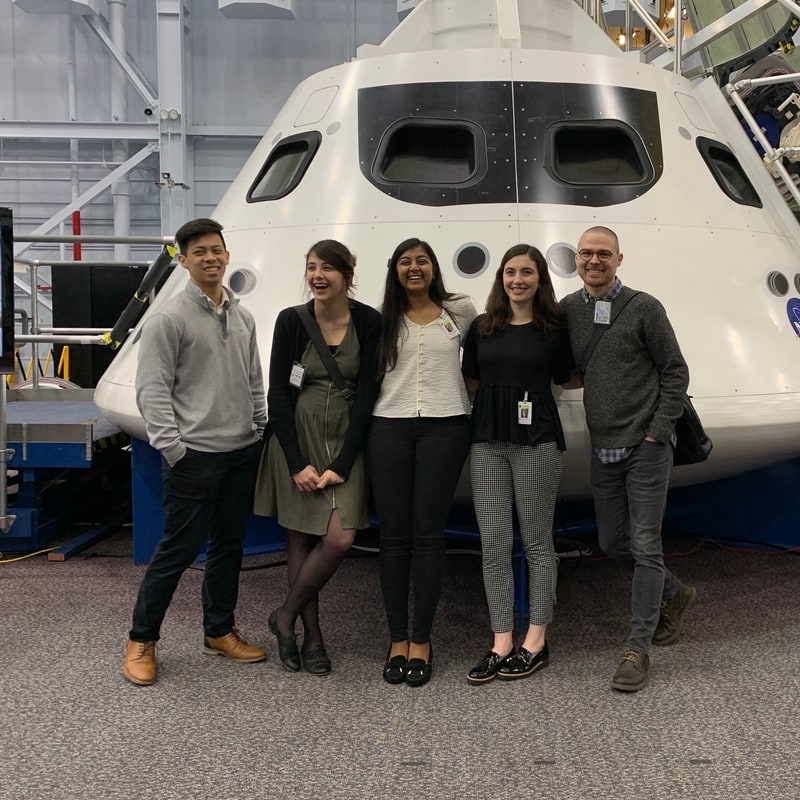 5 students on the NASA team visited Houston and stand in front of space craft