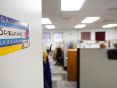 A handwritten sign in an office reads "Call Screening" 