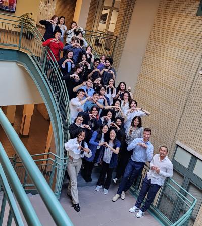 the summer researchers from 2023 stand on the large staircase in NSH