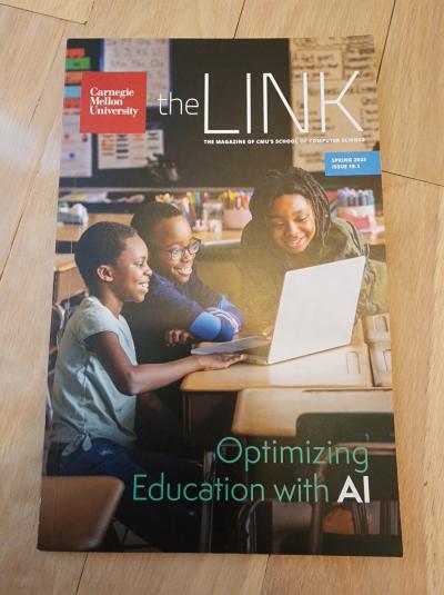 Spring 2025 issue of The Link magazine, front cover photo is of 3 young children facing a laptop while sitting at a desk in a classroom