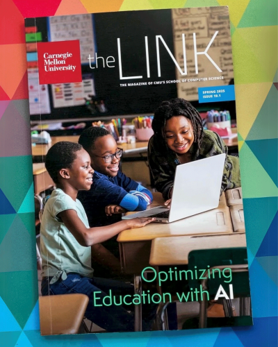 Spring 2025 issue of The Link magazine on a bright background. The front cover photo is of 3 young children facing a laptop while sitting at a desk in a classroom