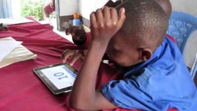 Child interacting with IPad