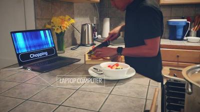 sensors in the kitchen recognize the sound of someone chopping vegetables and displays "chopping" on laptop screen