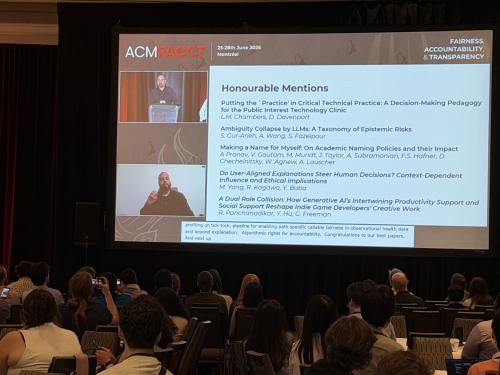 screen at a conference with honorable mention paper awards listed