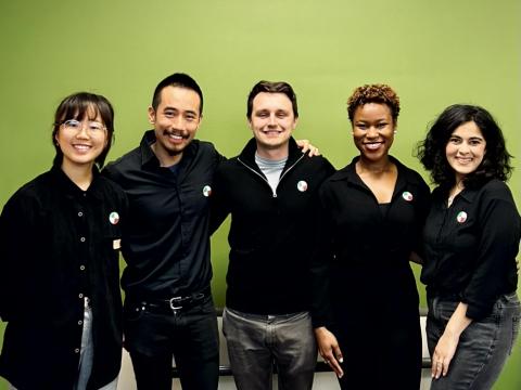 MHCI team Consumer Reports stands side by side in front of The Green Wall 