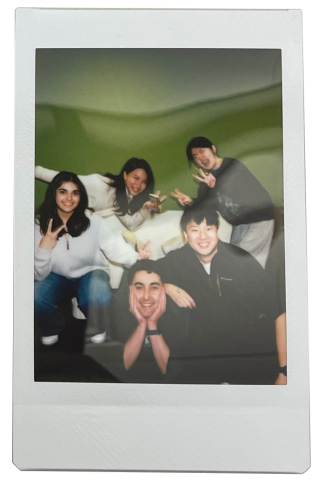 Team MARi in a polaroid style photo in front of The Green Wall
