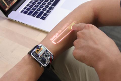 smartwatch on right wrist projecting the interface onto the wearer's forearm