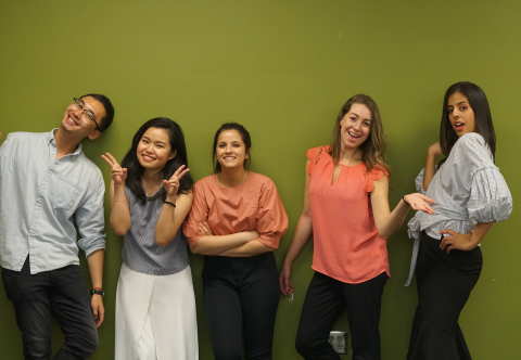 5 students of the 2019 AEO team in front of the infamous MHCI green wall 