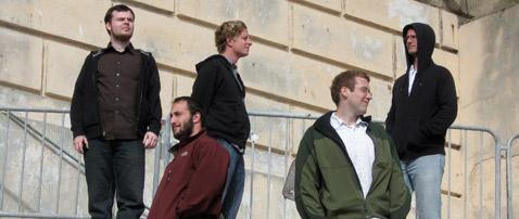 the 5 team members of TEAMNASA standing on stairs outdoors and facing different directions