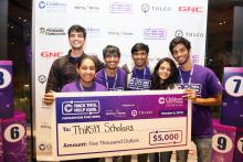team of hackthon student winners hold large check for $5000