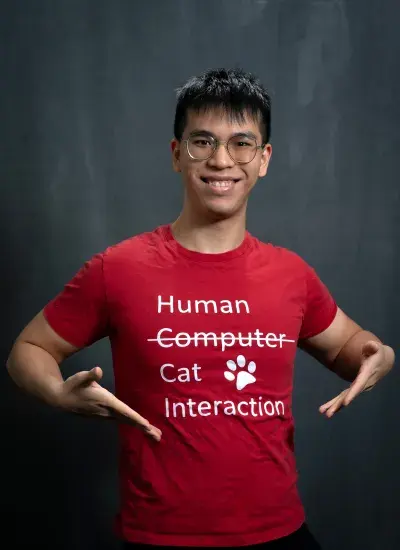 Eason Chen wears a custom, one of a kind, red HCI t-shirt. The word Computer is crossed out and replaced with Human-Cat Interaction.