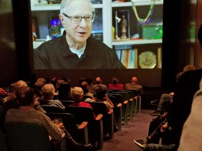 guests watch the HCII retrospective video inside the Warhol auditorium