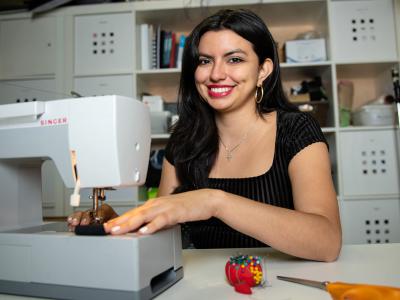 Ashley Burbano uses a sewing machine in the lab