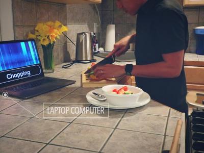 sensors in the kitchen recognize the sound of someone chopping vegetables and displays "chopping" on laptop screen
