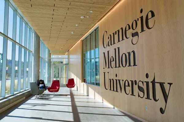 Inside the Tepper building this wooden wall has the Carnegie Mellon University wordmark cut into the wood
