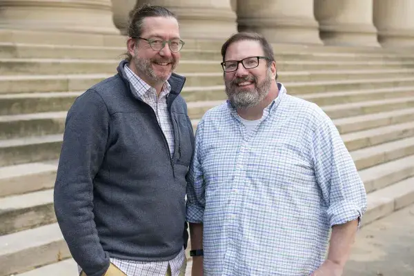 Bier and Stamper stand side by side on the steps outside of the Mellon Institute building