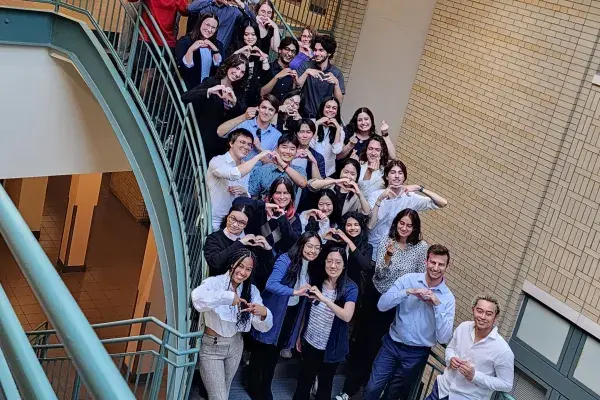 the summer researchers from 2023 stand on the large staircase in NSH