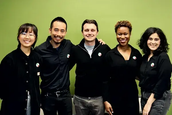 MHCI team Consumer Reports stands side by side in front of The Green Wall 