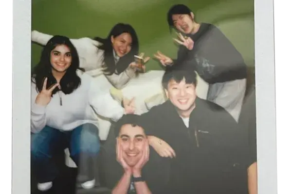 Team MARi in a polaroid style photo in front of The Green Wall