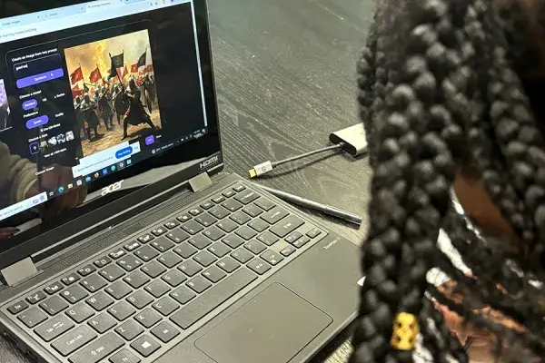 A laptop screen displays what looks like medieval forces prepped for battle.