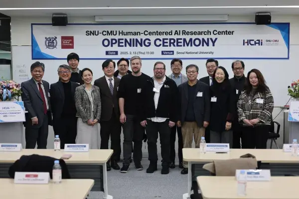 group of 14 SNU and CMU faculty standing in front of a banner that reads Opening Ceremony for the new HCAI center