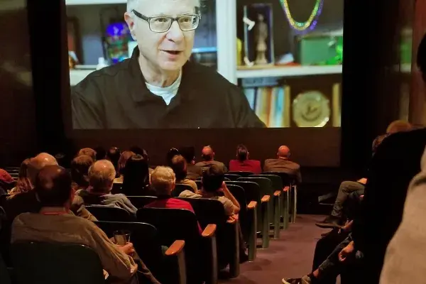 guests watch the HCII retrospective video inside the Warhol auditorium