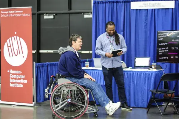 Patrick Carrington speaks with an athlete at the NWBT about SpokeSense